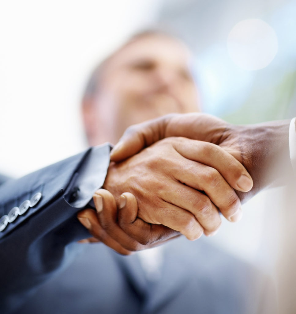 Handshake Closeup of business people shaking hands over a deal